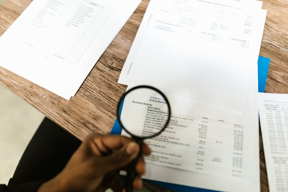 Magnifying glass over financial statements analyzing business note valuation