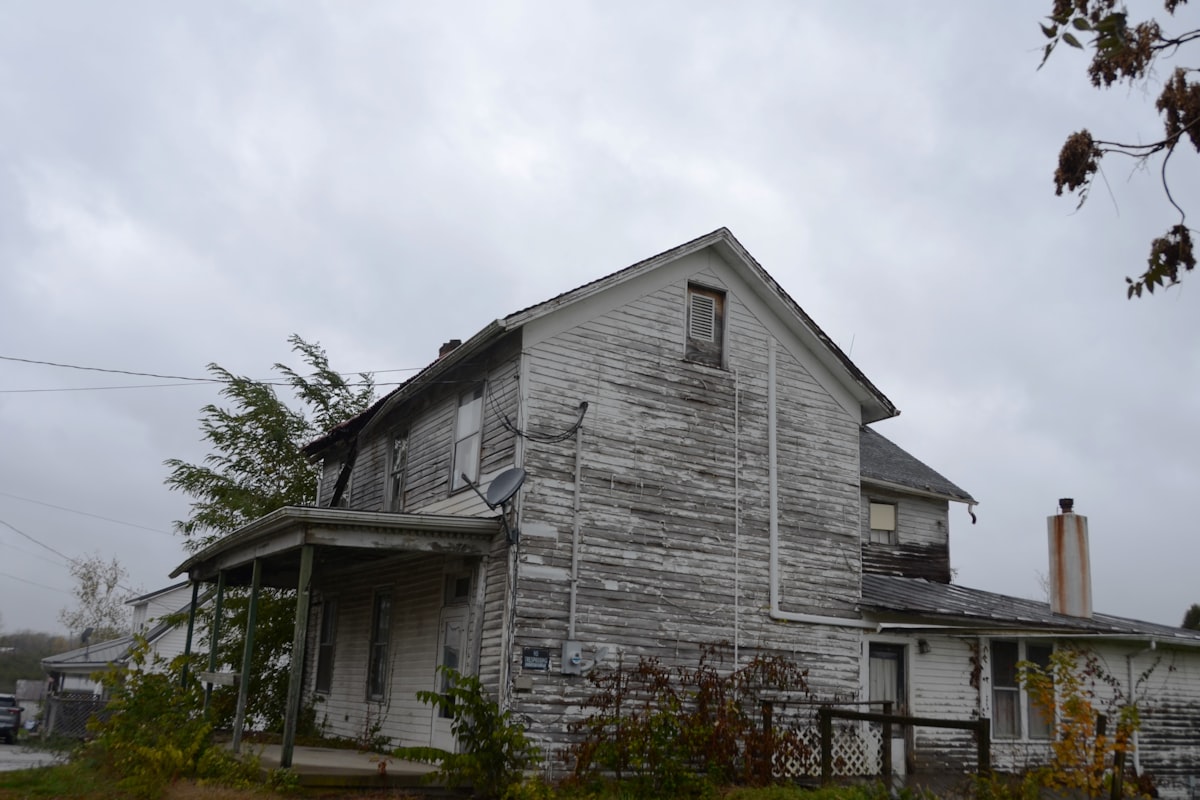 House needing repair — sub-performing note analogy of fixing a leaky roof to restore value